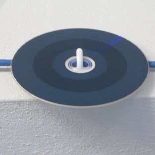 A cd on a white surface

AI-generated content may be incorrect.