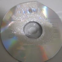 A close-up of a cd

AI-generated content may be incorrect.