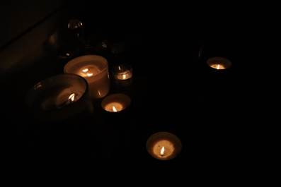 A group of candles in the dark

AI-generated content may be incorrect.